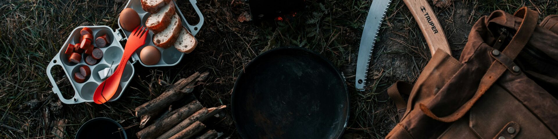 a campfire with a bunch of cooking utensils