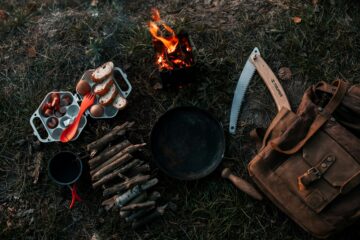 a campfire with a bunch of cooking utensils