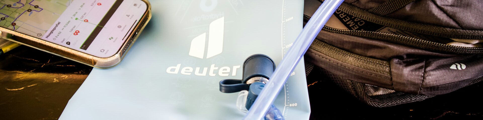 Hiking gear: water bladder, backpack, and phone map.