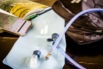 Hiking gear: water bladder, backpack, and phone map.